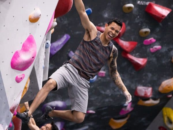 Happy man Rock climbing indoor